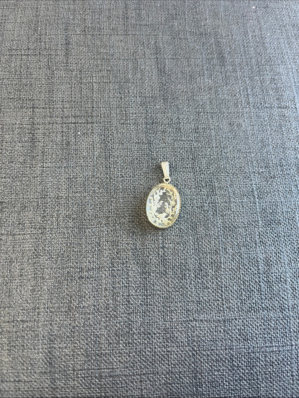 Etched glass with bird sitting in flowers in gold toned pendant